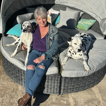 Michele sitting with her two dalmations